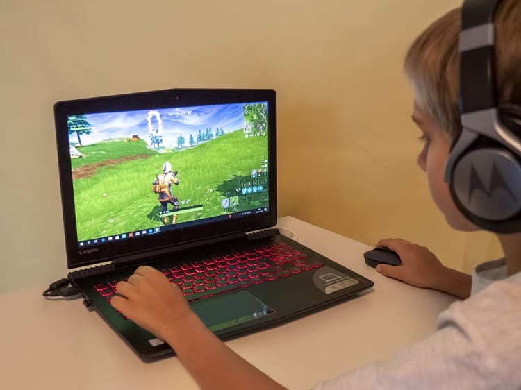 Vilnius, Lithuania - November 12, 2018: Boy playing Fortnite. Fortnite is online video game developed by Epic Games
