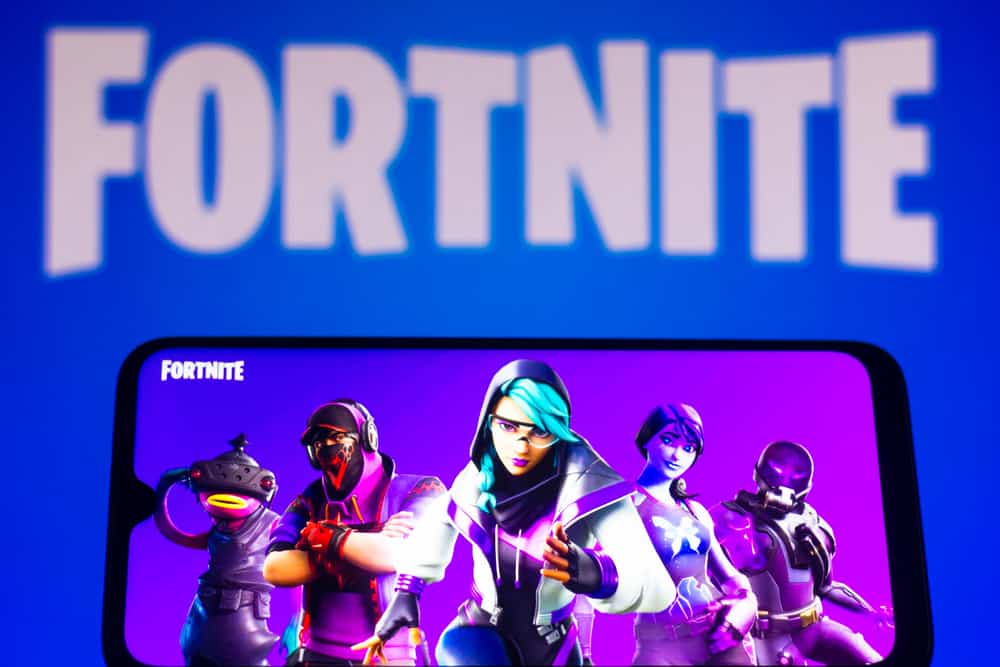 March 28, 2021, Brazil. In this photo illustration the Fortnite logo is seen on a smartphone and a pc screen.